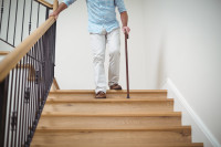 Person walking downstairs using a railing