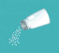 White salt being poured from a salt shaker